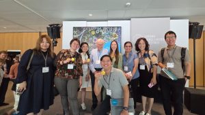 Group of people stand together for photo holding medals