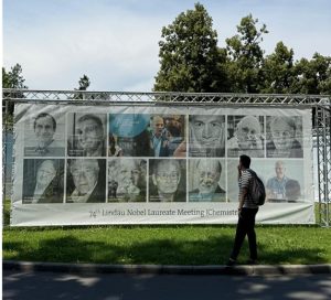 A person stands in front of sign at Lindau Meeting